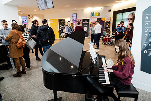 Pupil playing a grand piano