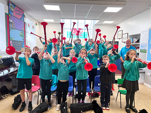 Children in a classroom playing pBuzz