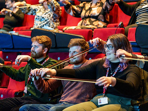 Three adults with musical instruments